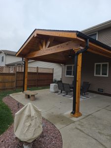 backyard patio with an attached wooden pavilion